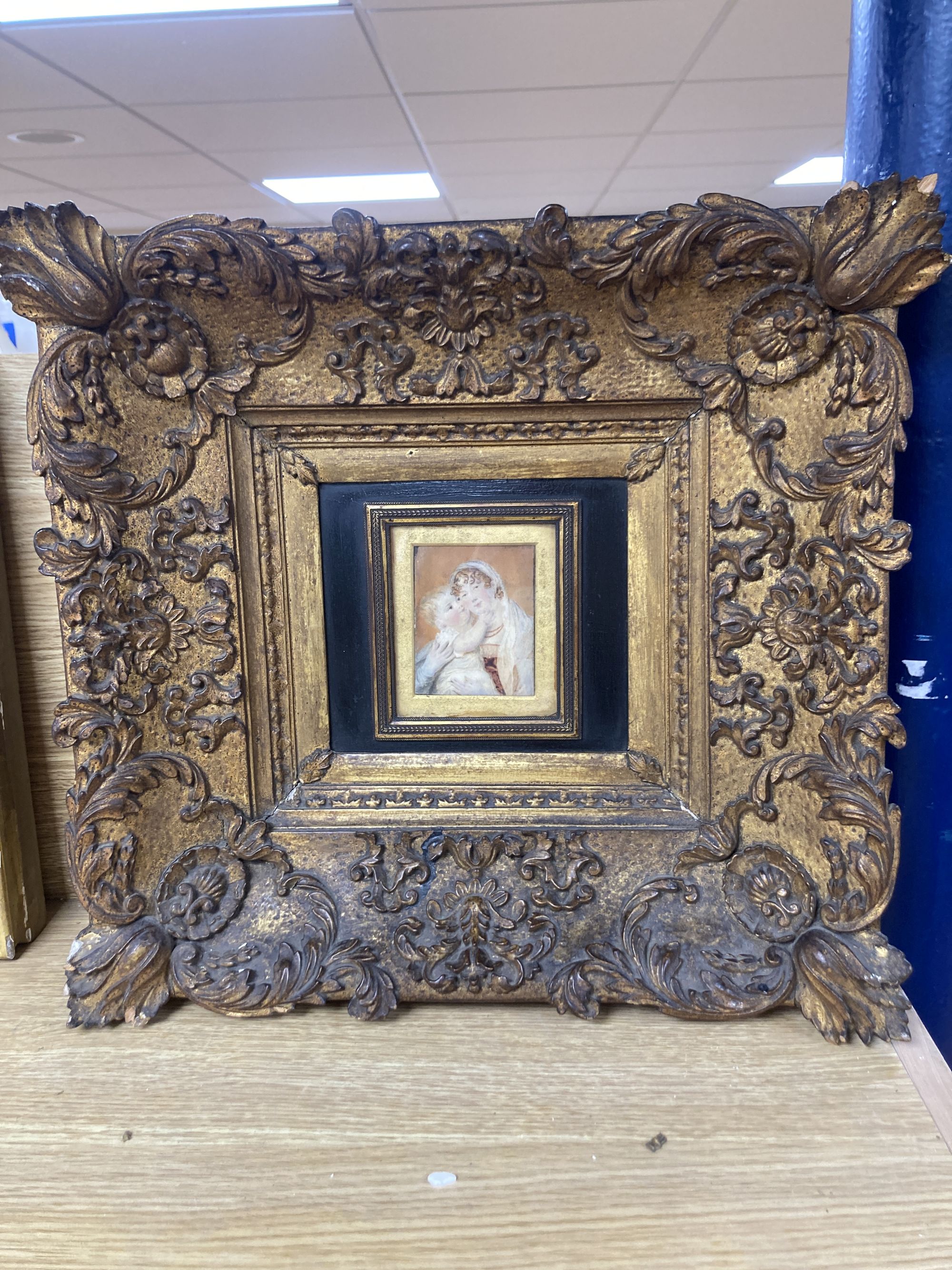 19th century English School, oil on ivory, Miniature portrait of a mother and child, 8.5 x 6.5cm, housed in an ornate gilt gesso frame,